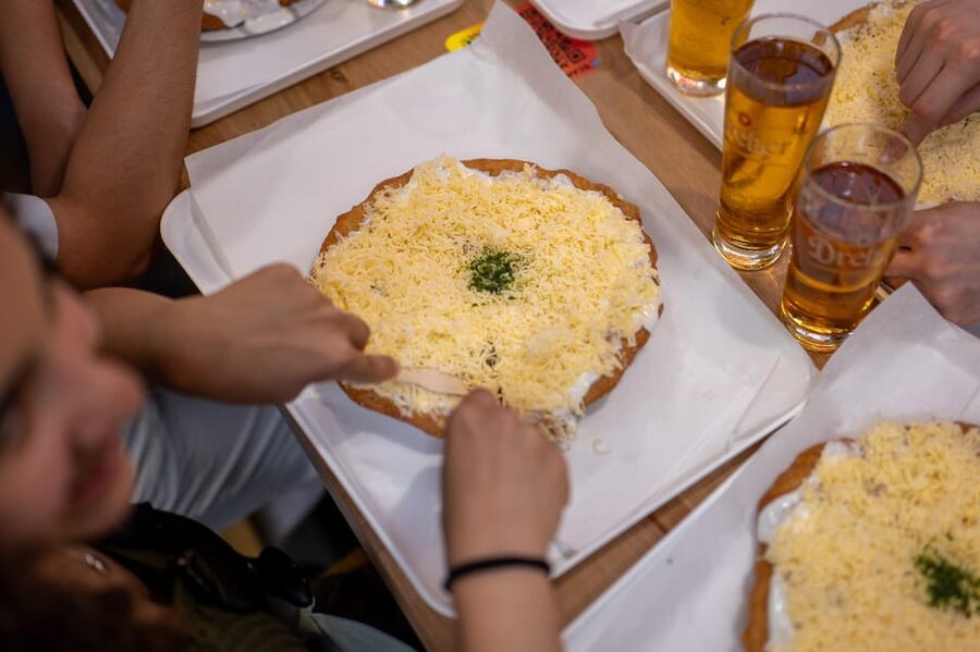 Budapest: Guided Food Tour with Wine, Beer, and Shots - Street food stops: lángos and Hungarian soup, eaten the right way